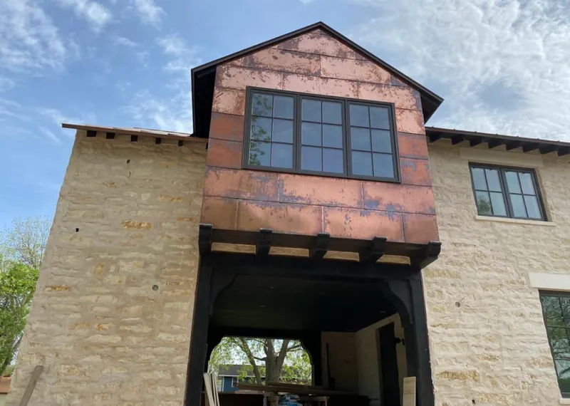 Copper metal panel facade on a stone building for Metal Roof Coating in Lucas